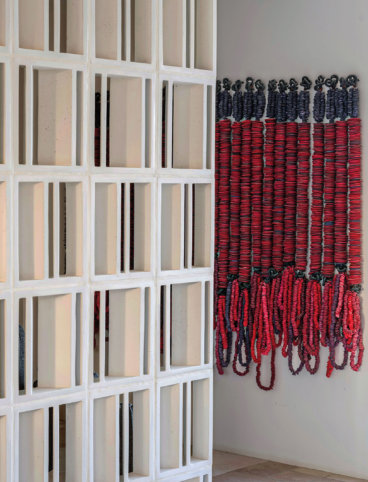 A wall with several red and blue ribbons hanging on it