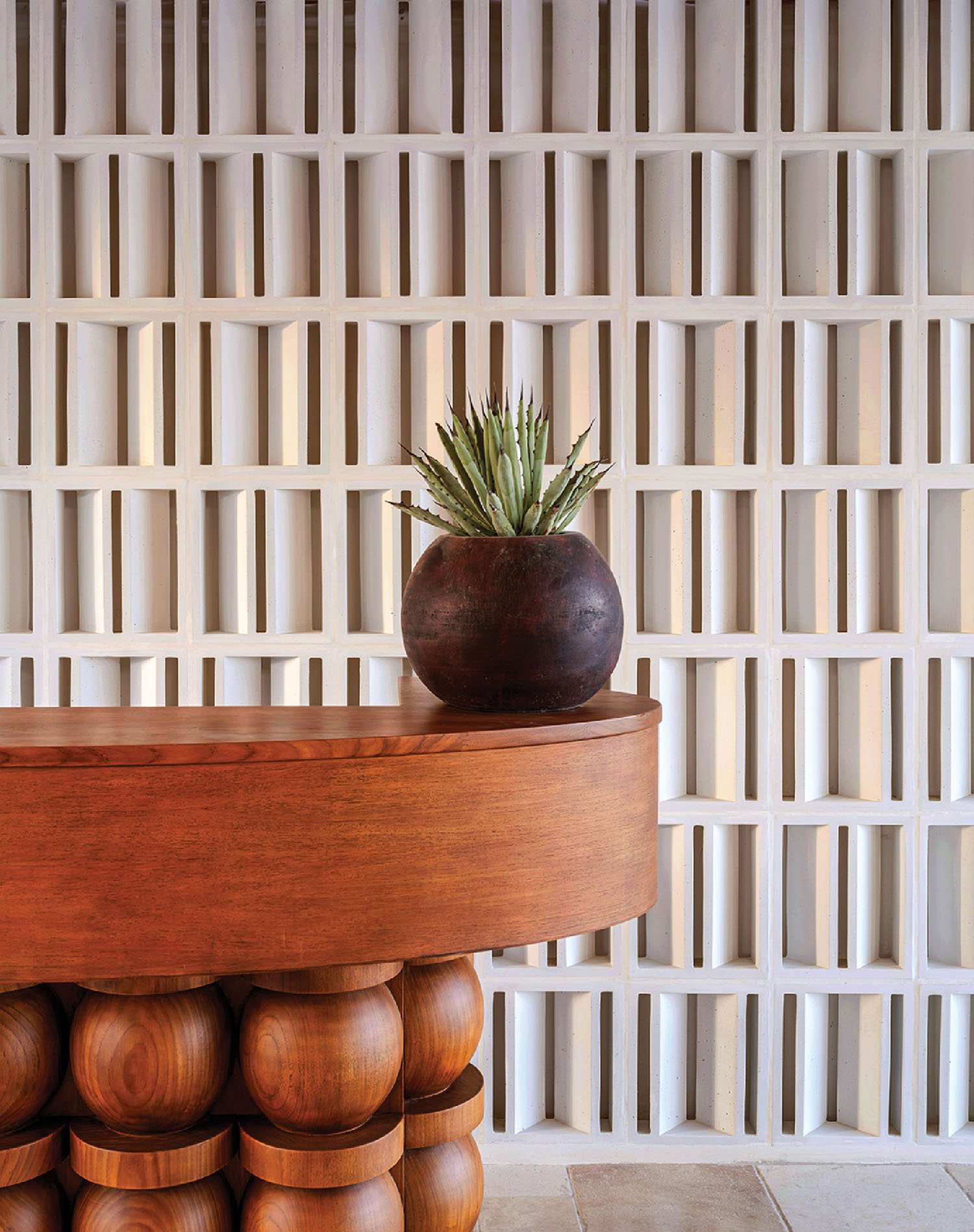 A wooden table with a plant on top