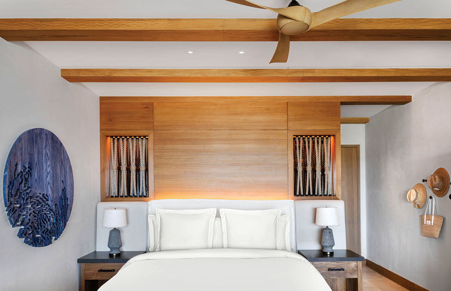 A bedroom with a bed and a ceiling fan