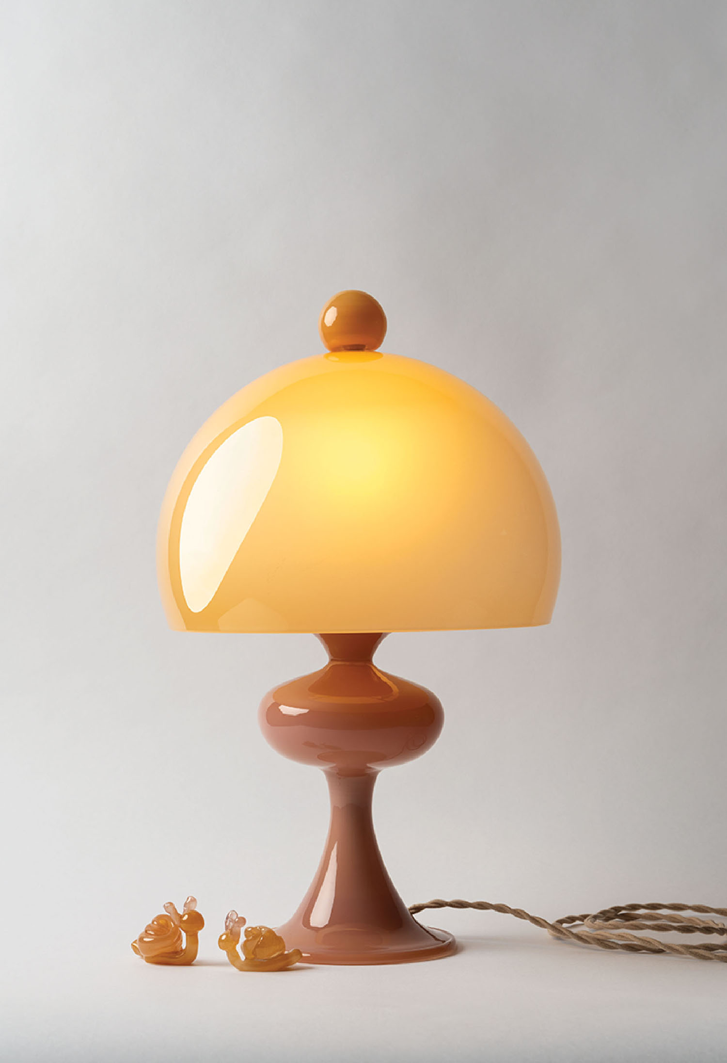 A lamp with a yellow shade on it