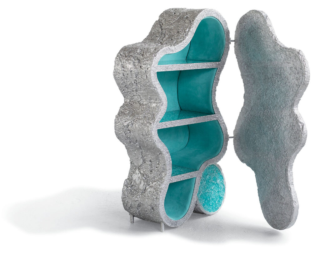A sculpture made out of concrete and a turquoise colored glass