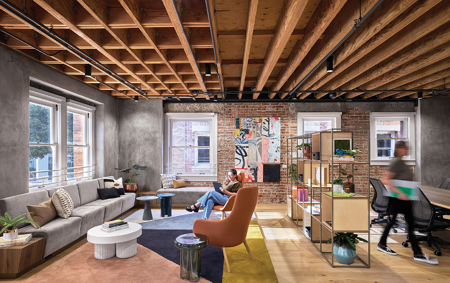 A living room with a couch, a chair, a table, and a television