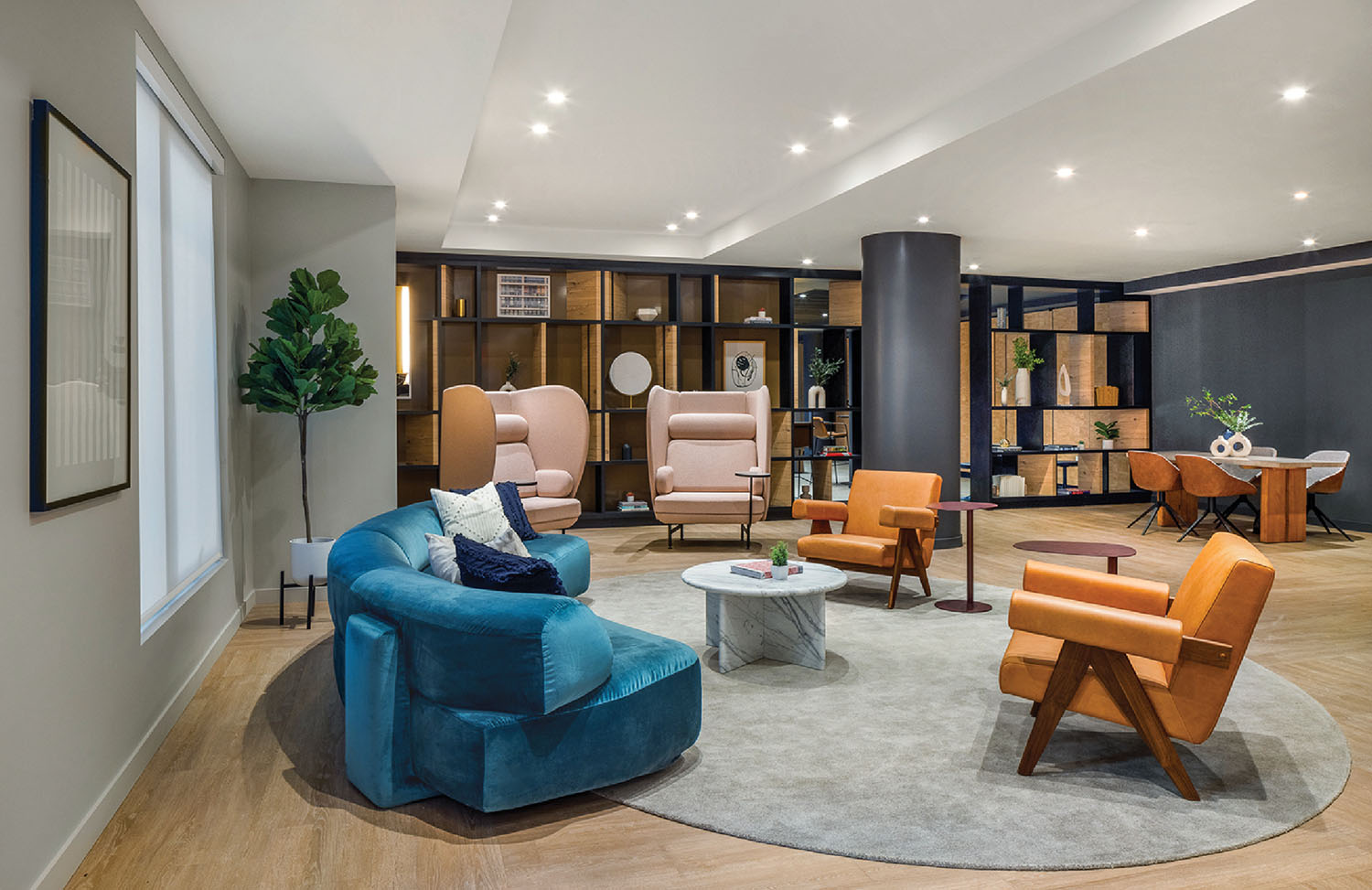 A living room with a blue couch and a blue chair