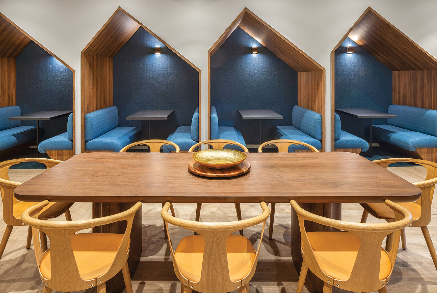 A dining room with a wooden table and chairs