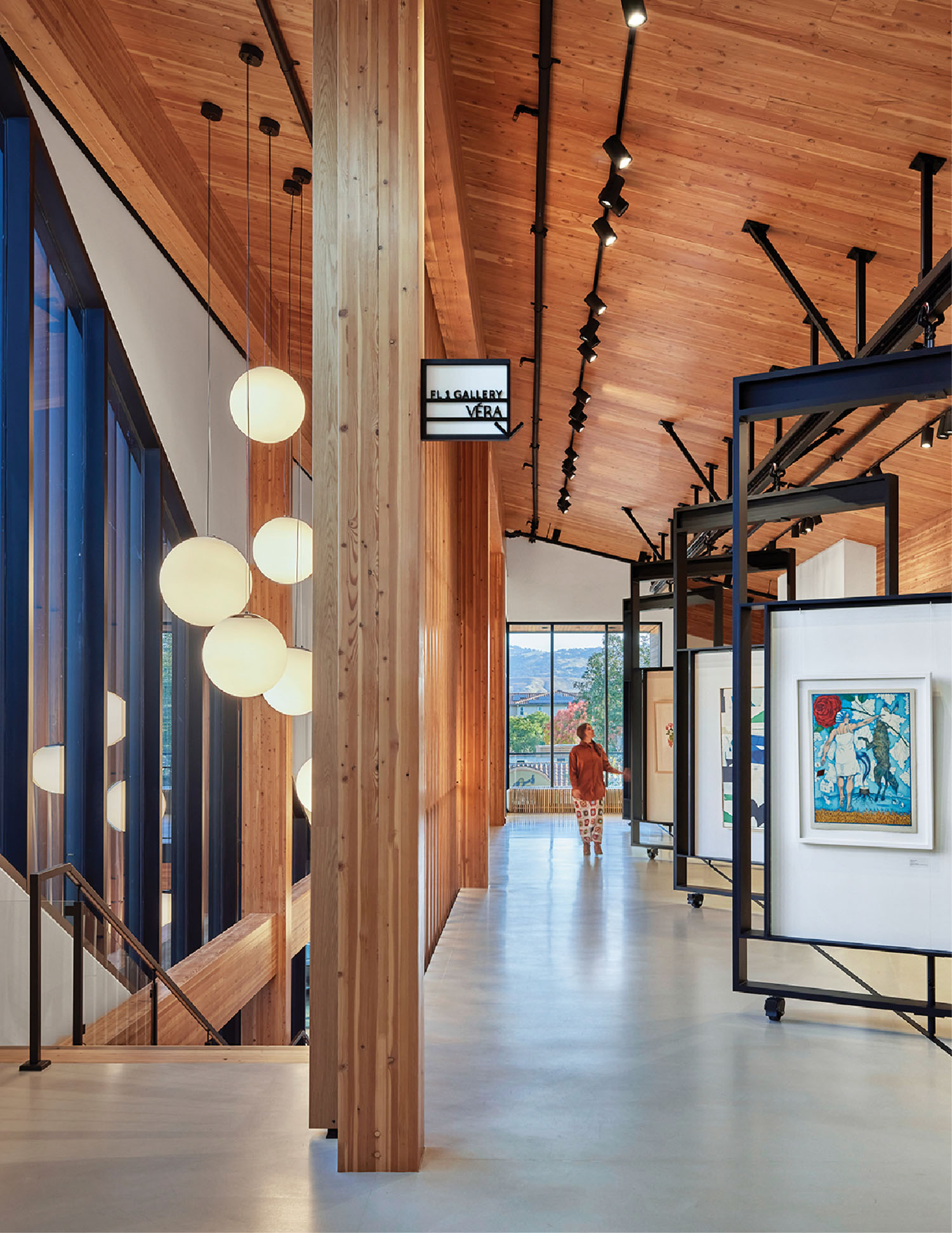 A long hallway with a large painting on the wall