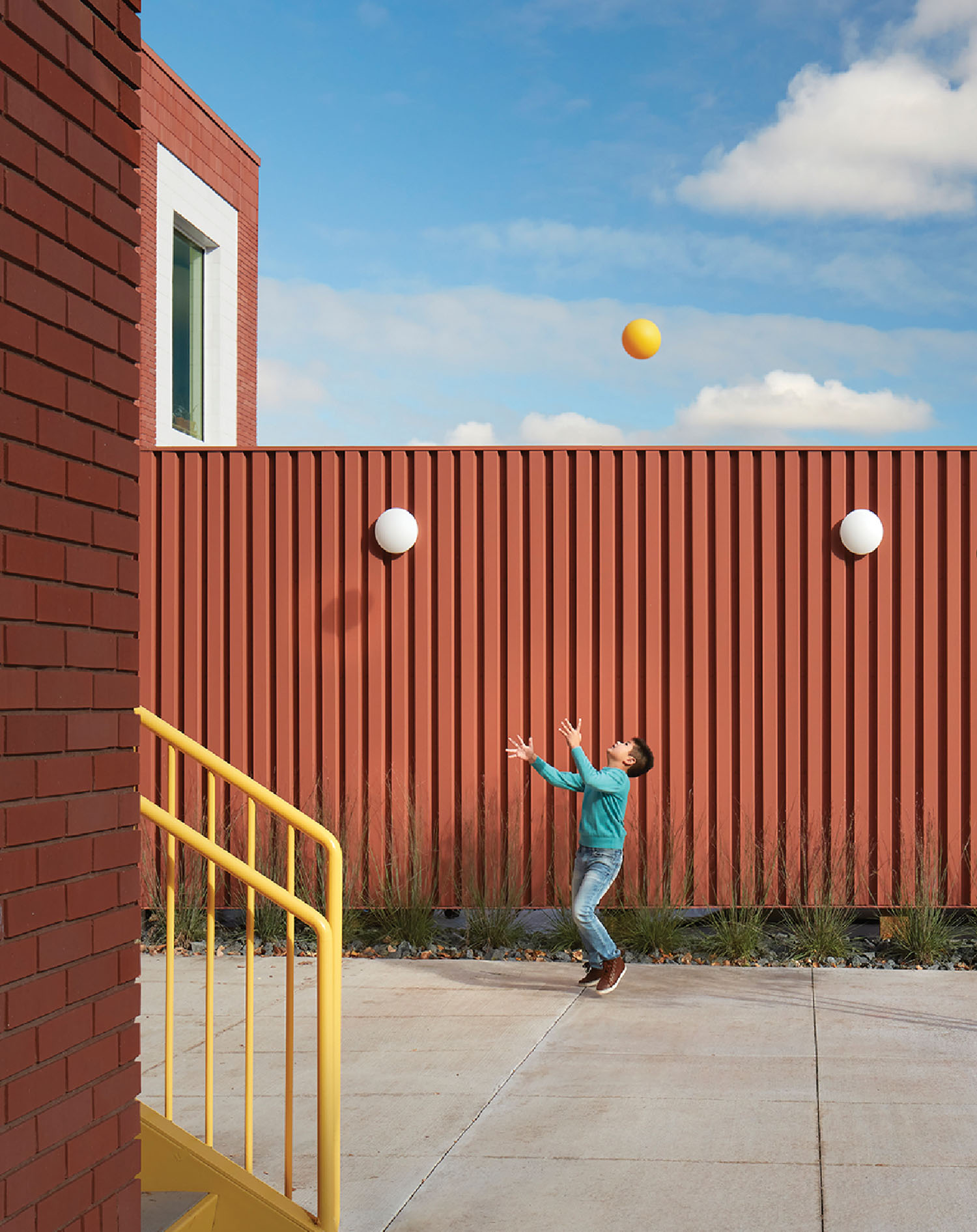 A person is playing with a ball in a courtyard