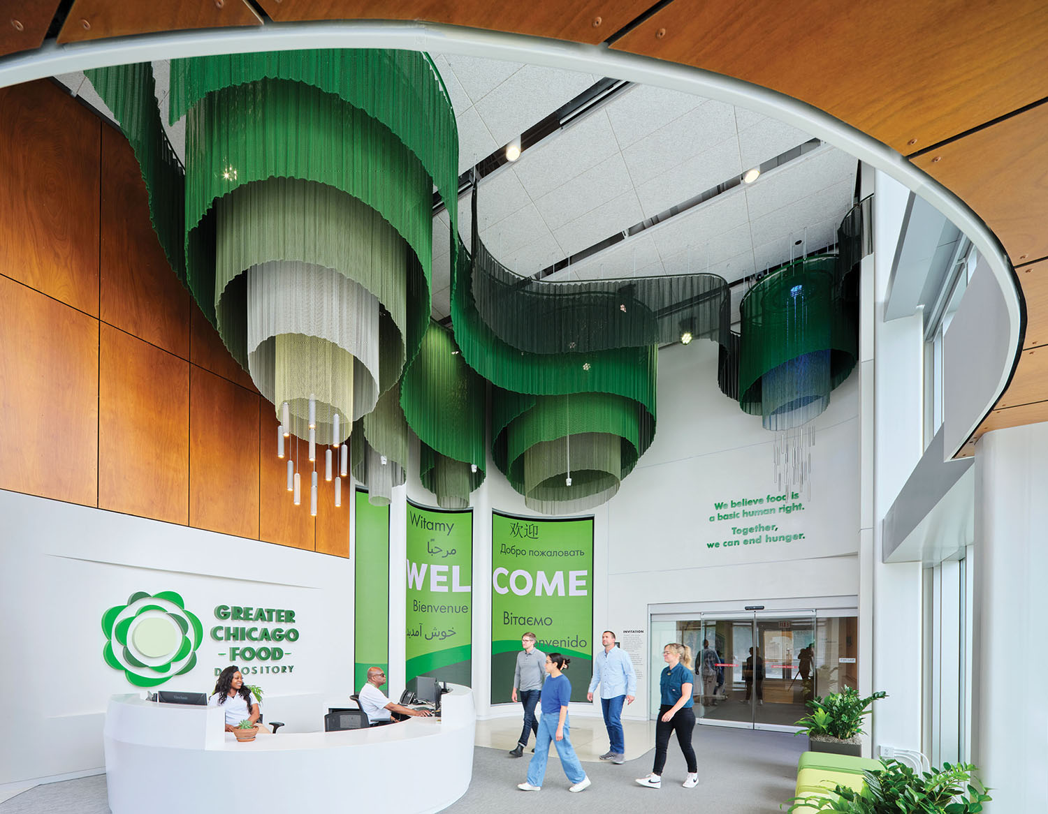 A large green and white lobby with a large green sign