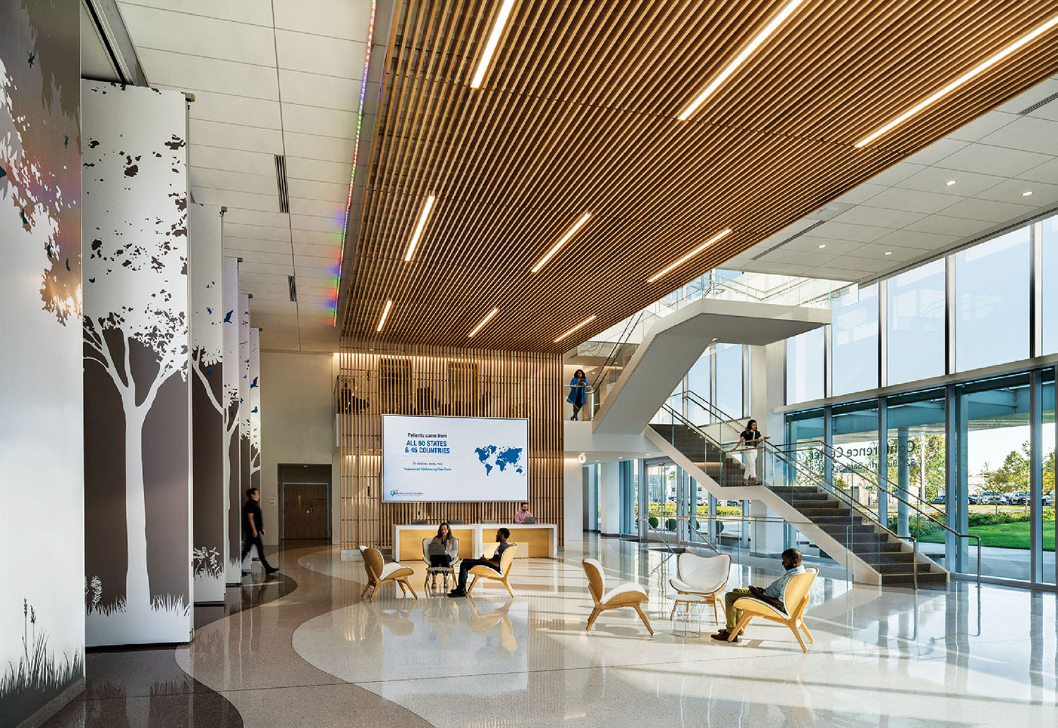 A large lobby with a large screen on the wall