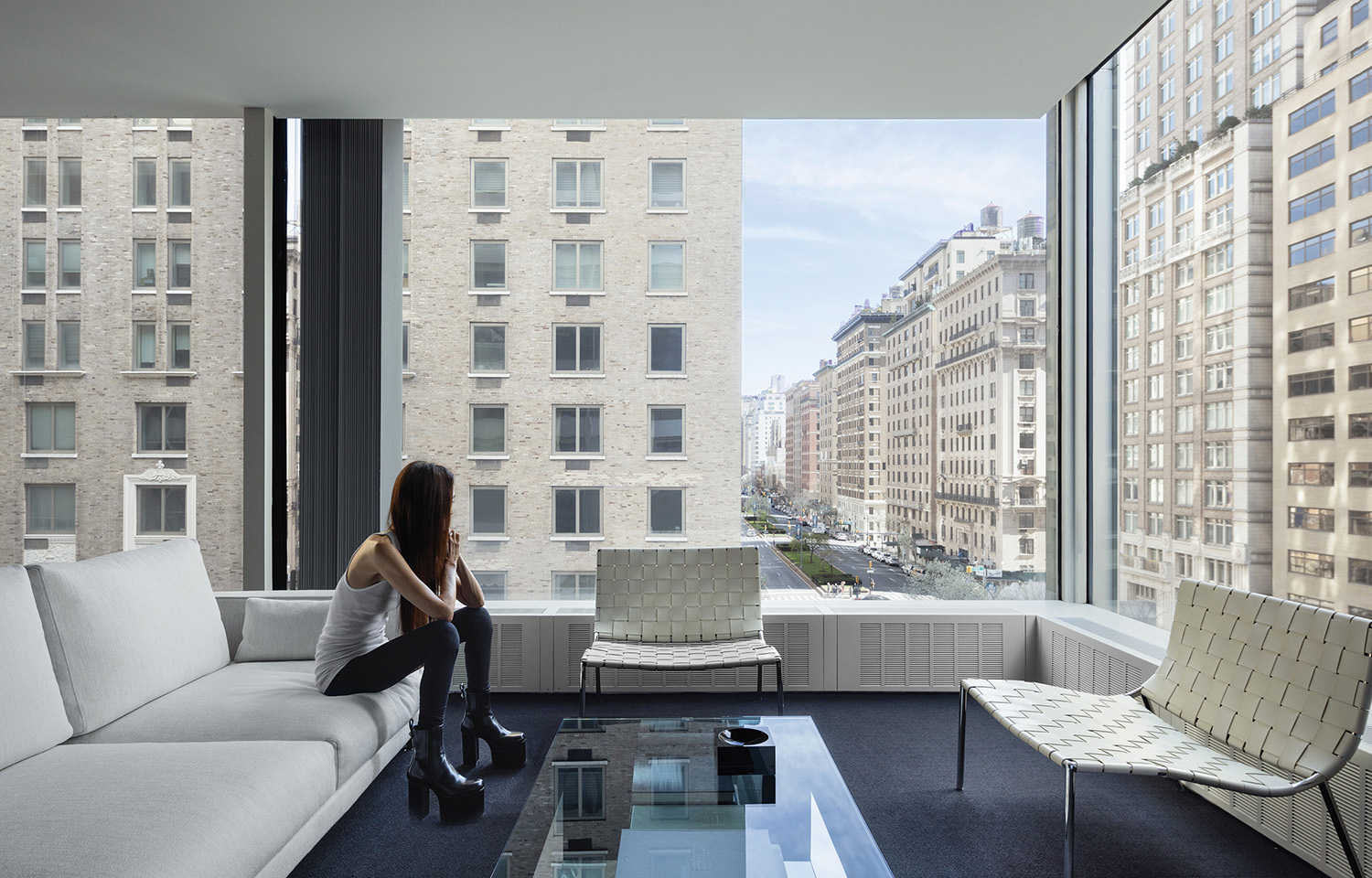 Vera Wang sitting on a couch in a living room.