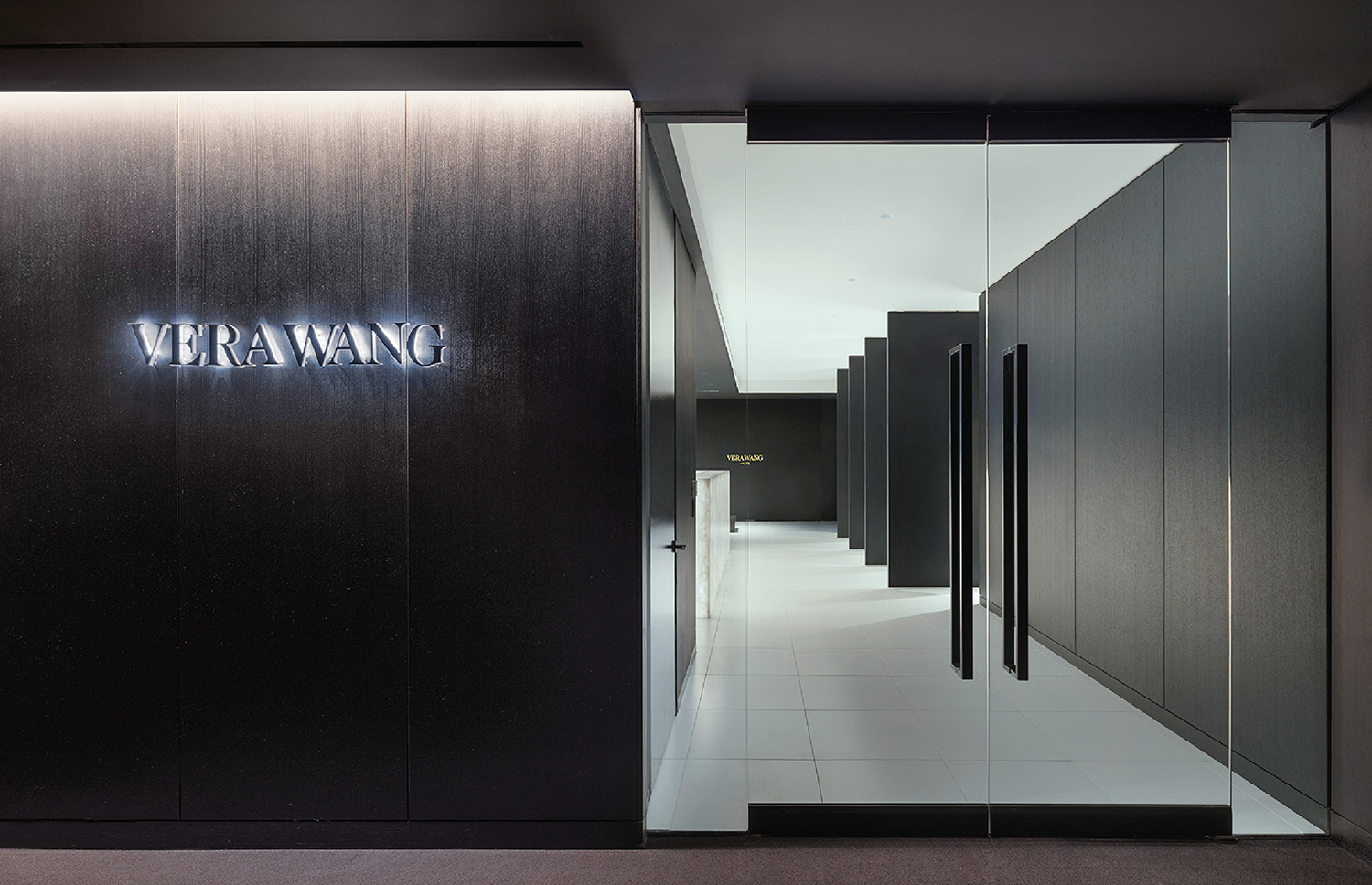 lobby area with dark black walls in Vera Wang office