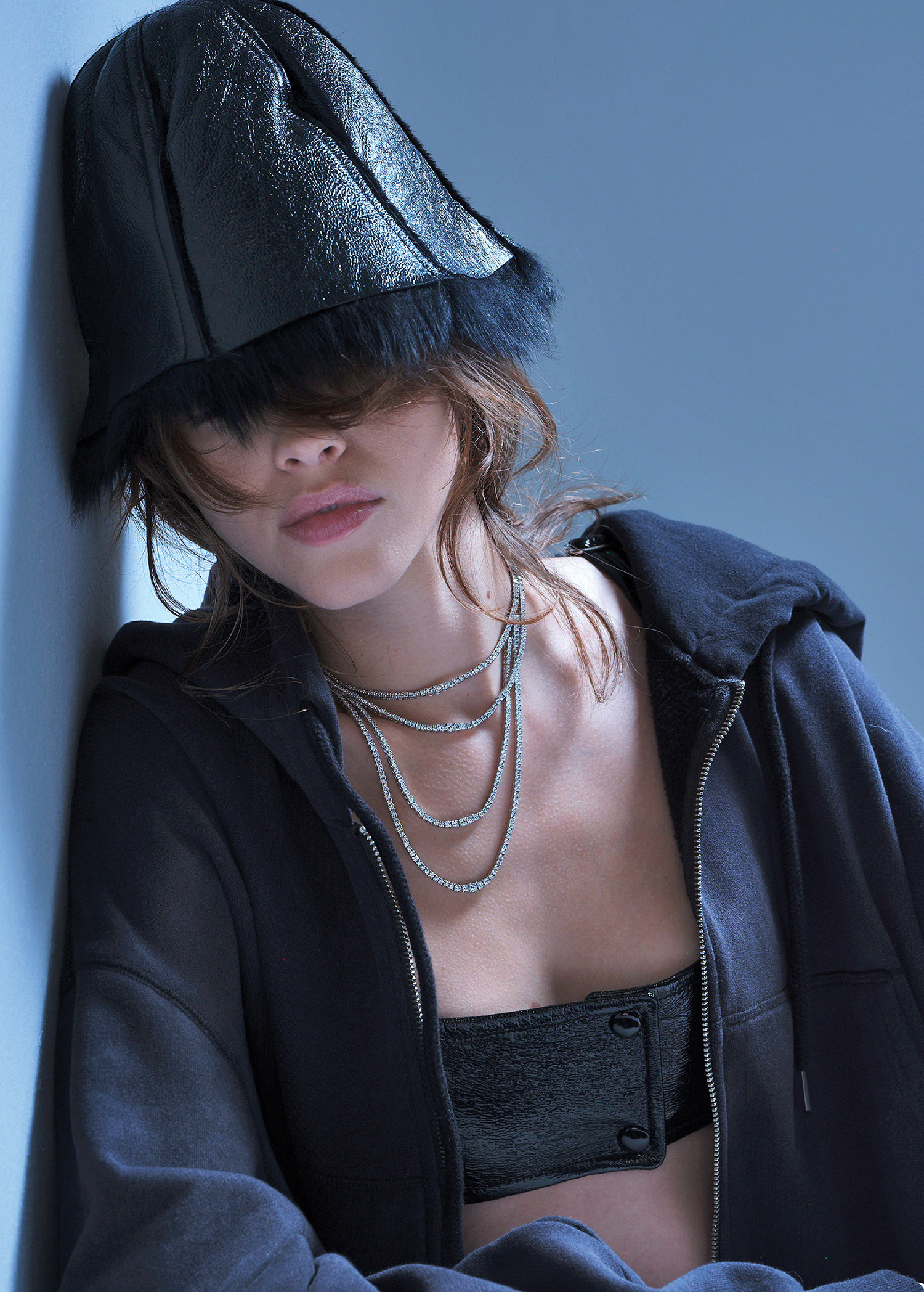A woman wearing a black hat and a black jacket.