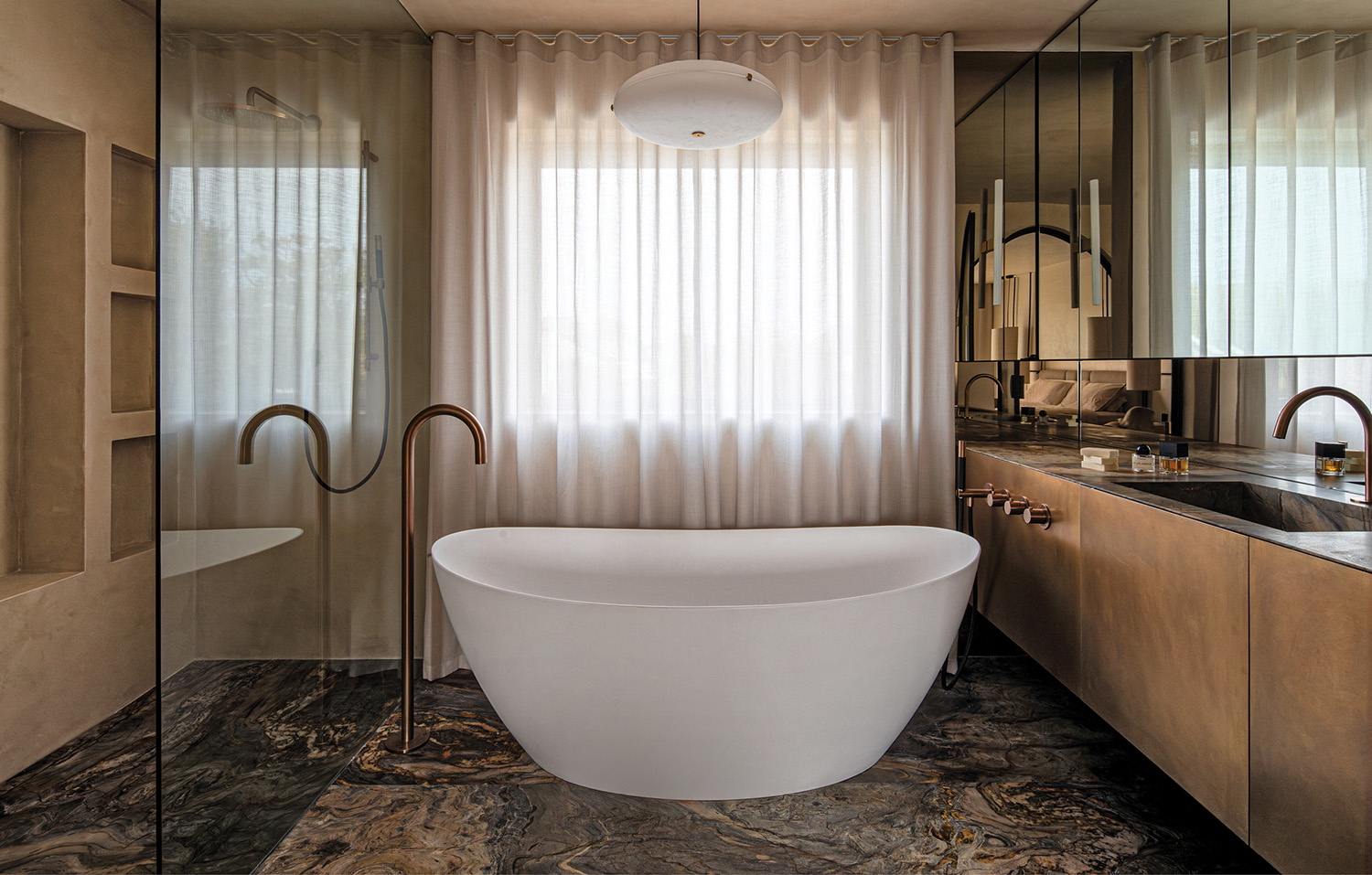 white bathtub in bathroom with bronze vanity
