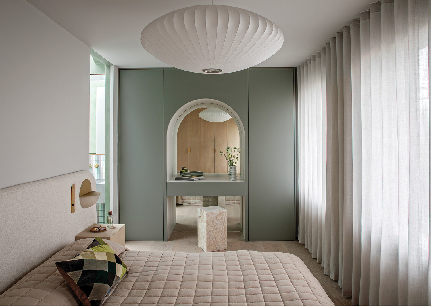 bedroom with built-in vanity and sage green walls