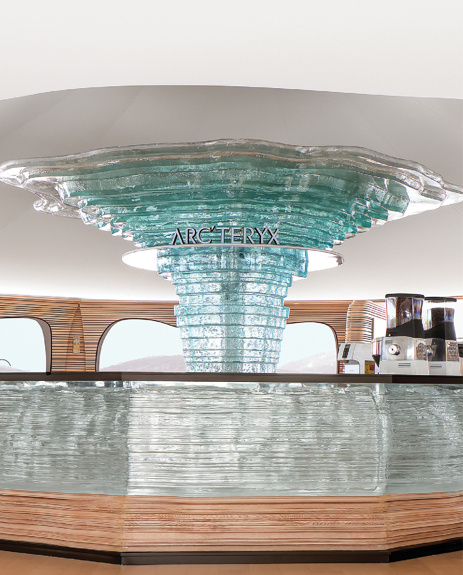 A glass fountain with a sign on top.