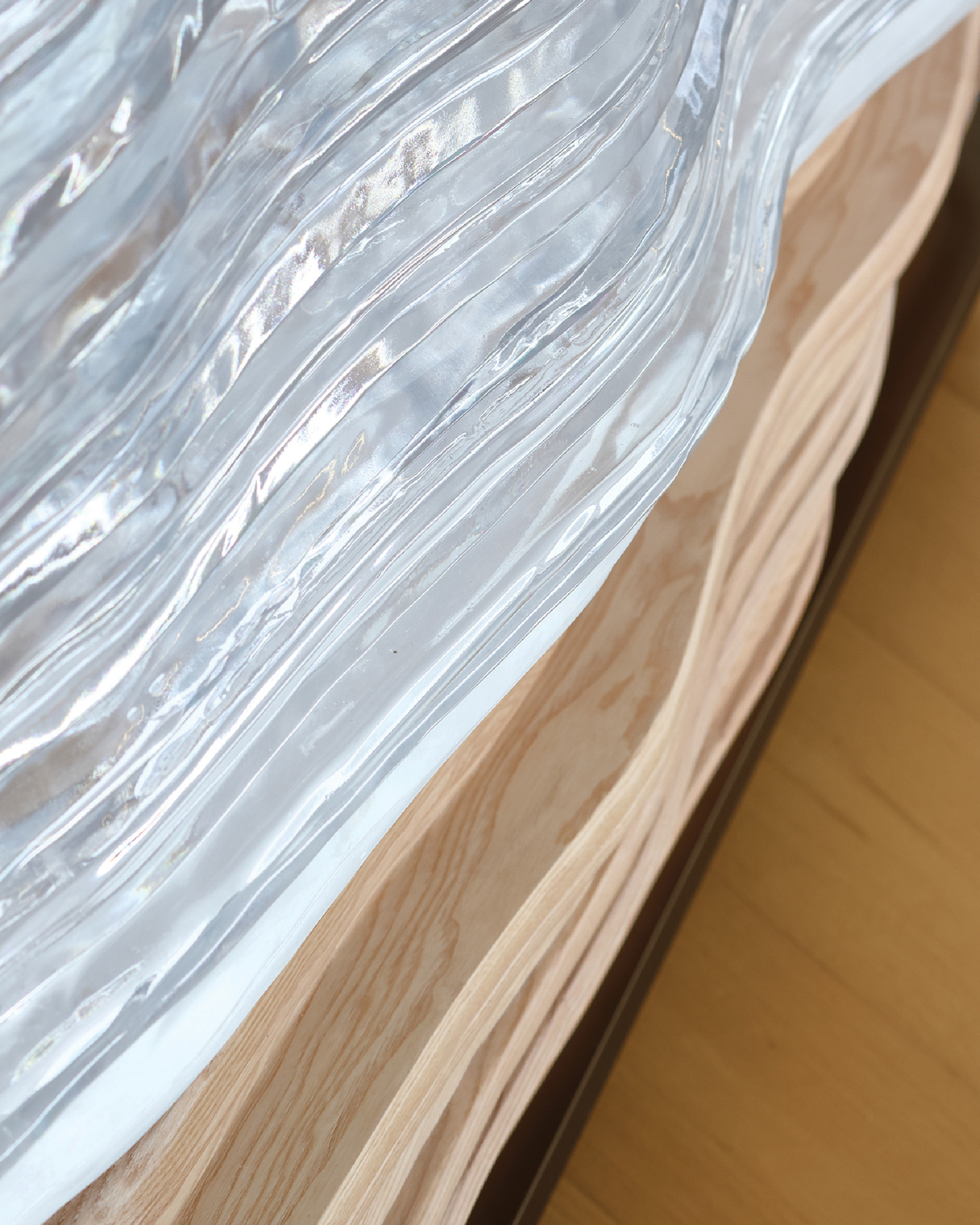 A close up of a bed with a plastic cover.