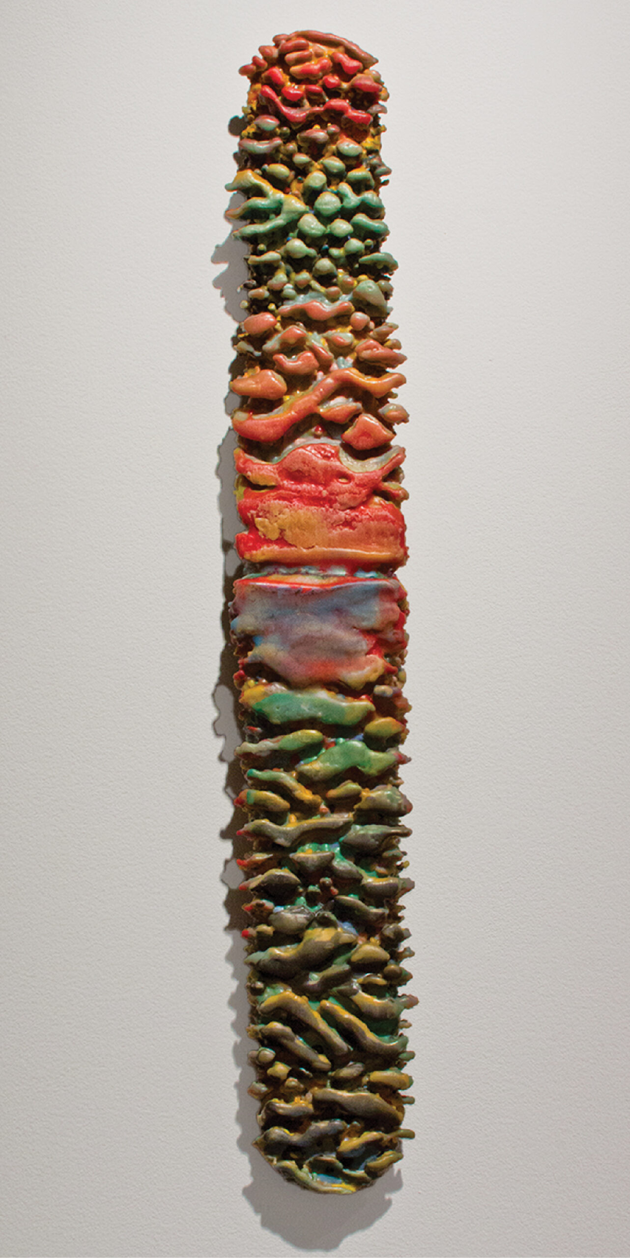 A sculpture made out of different colored objects.