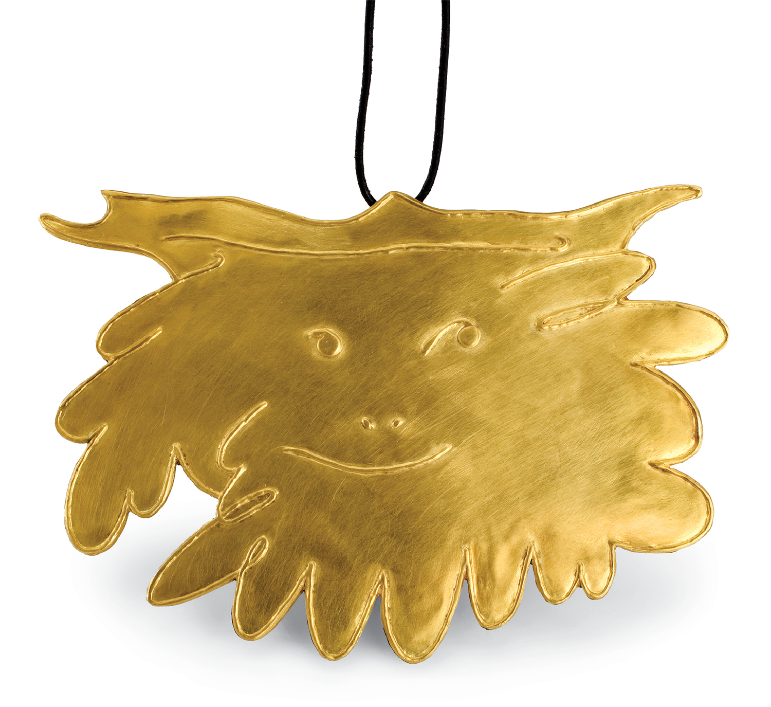 A gold pendant with a face on it.