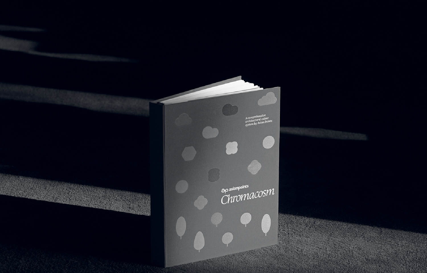 A book sitting on a table with a black background.