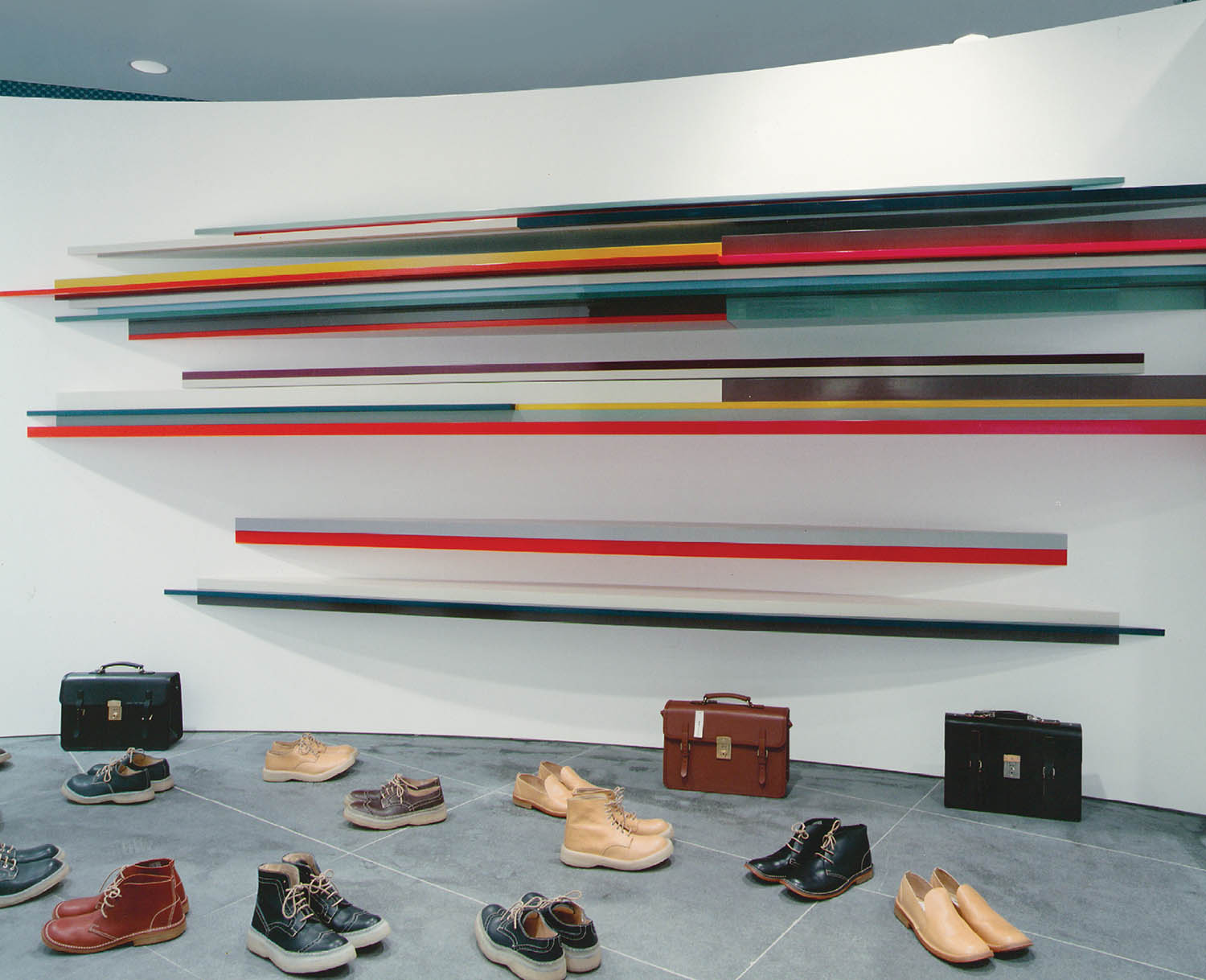 A wall with a bunch of shoes on it.