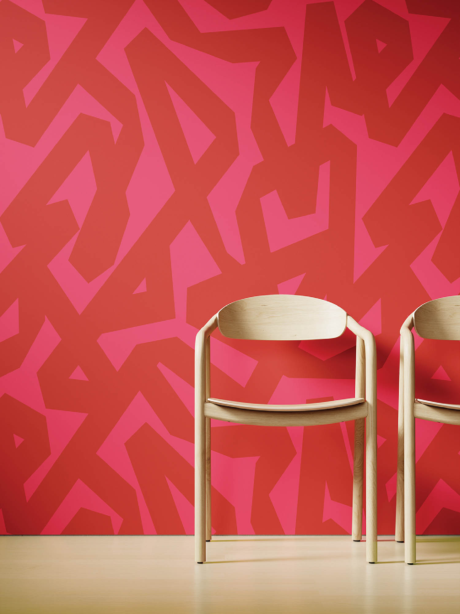Two chairs sitting side by side in front of a red wall.