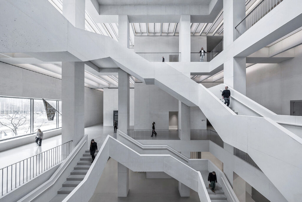 A large white building with a lot of stairs.