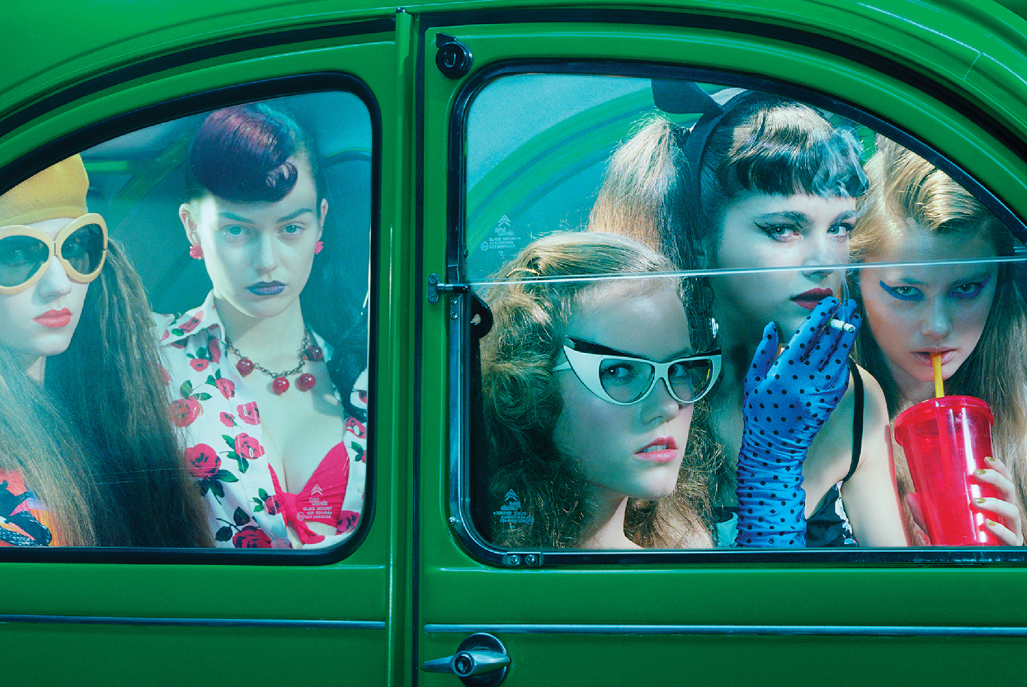 Three girls in a green car.