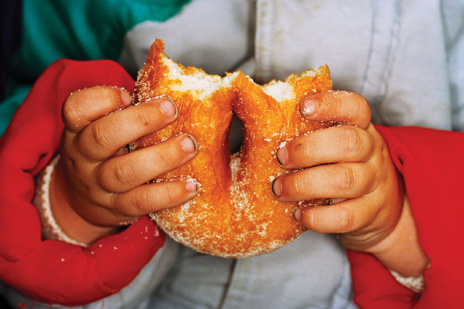 A person holding a dough dough with sprin.
