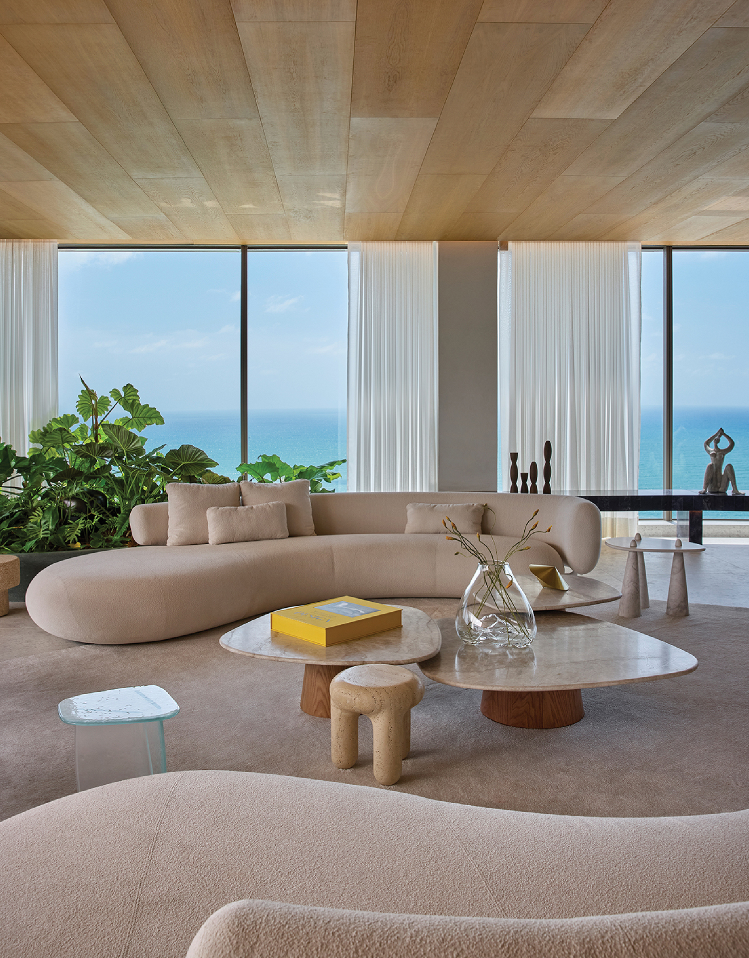 A living room with a large couch and a large window.