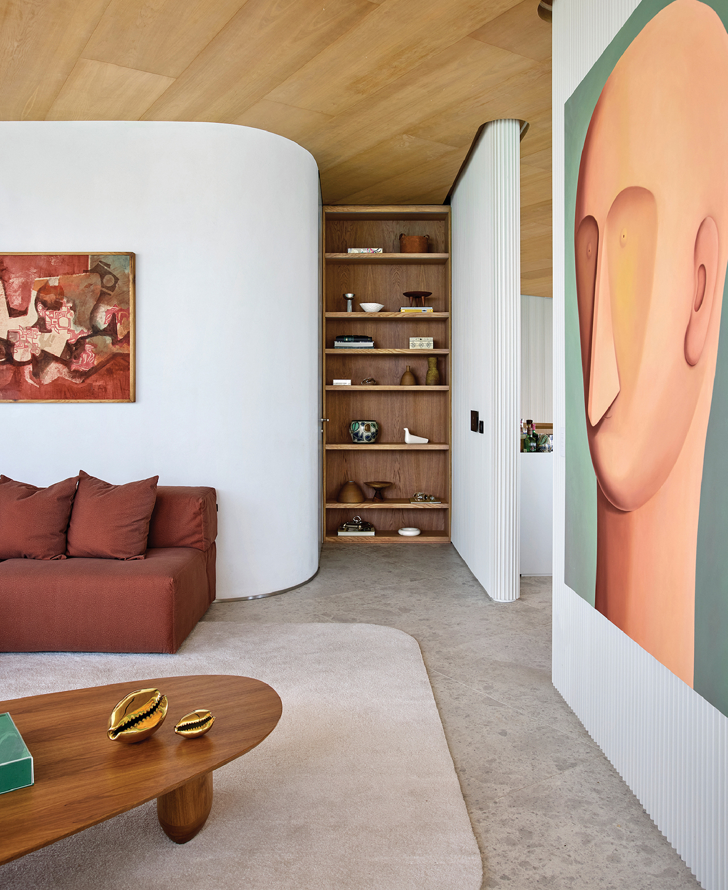 A living room with a couch and a painting.