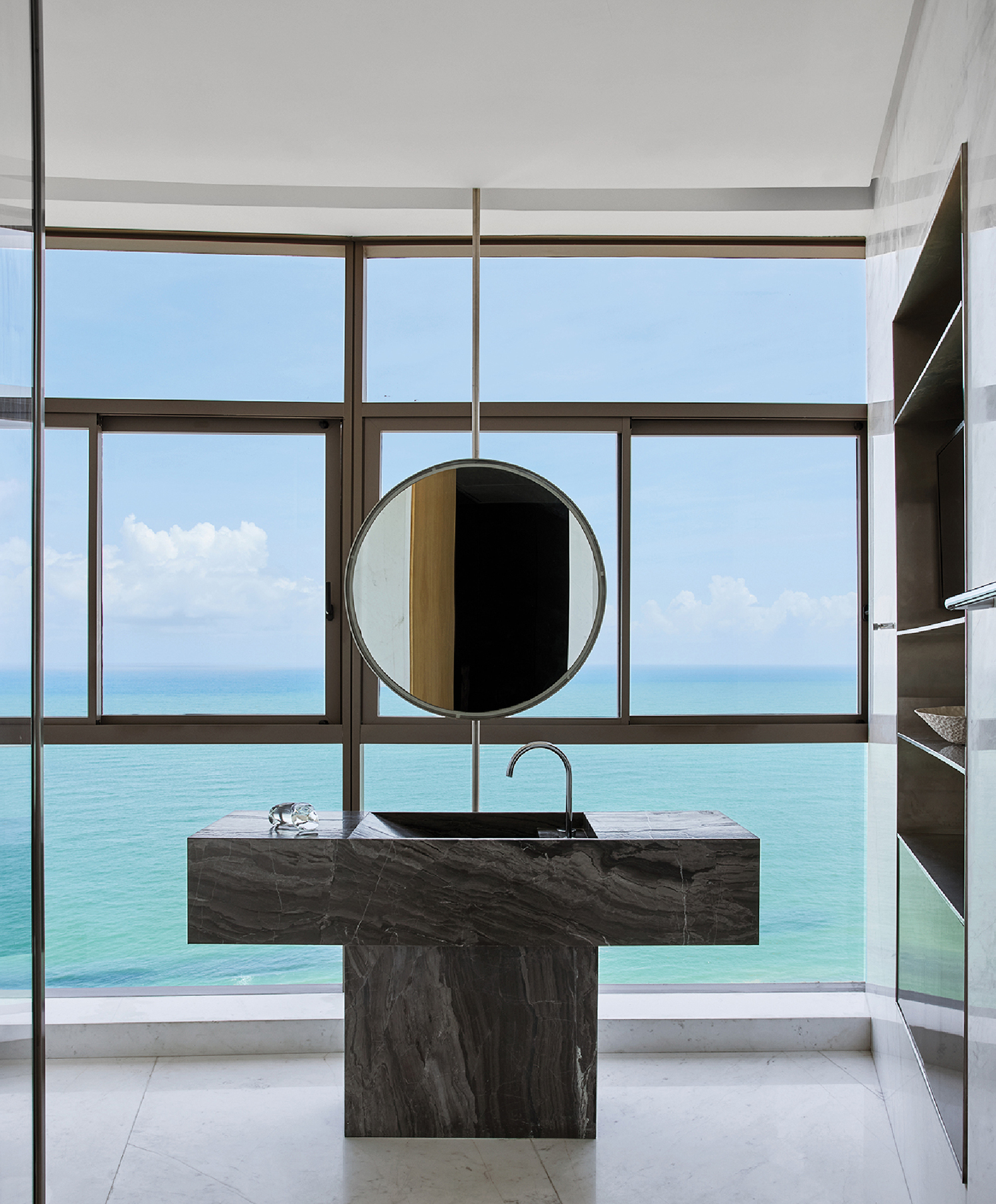 A bathroom with a large mirror and a sink.