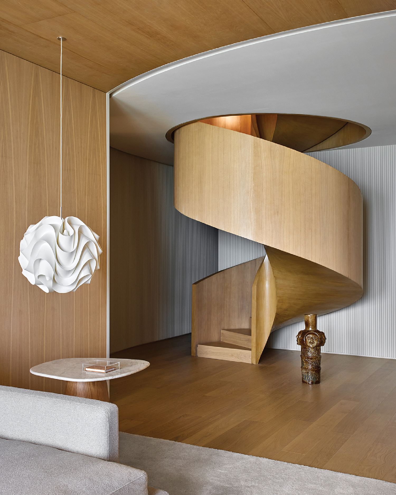 A living room with a spiral staircase.