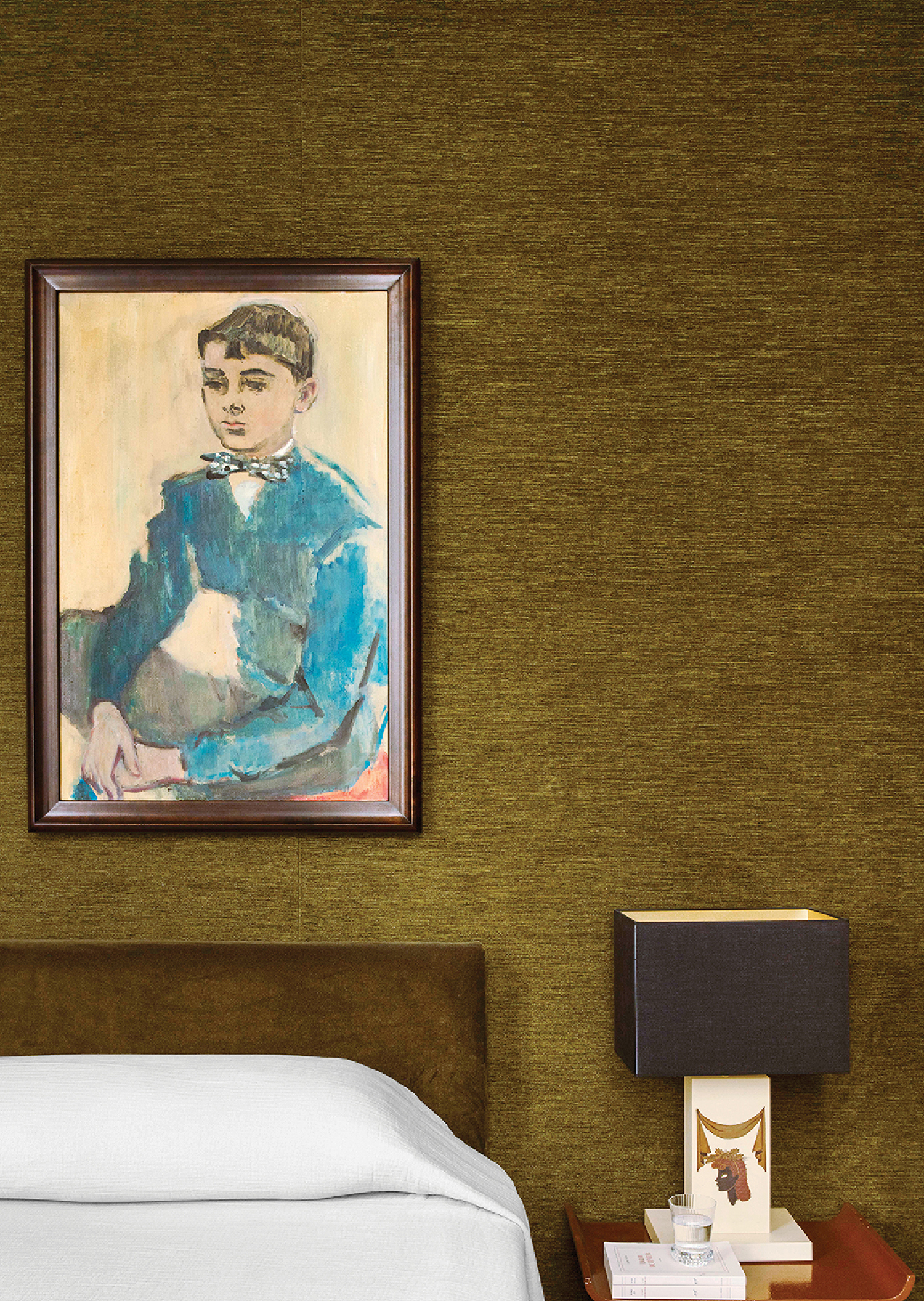 A bed with a painting on the wall above it.