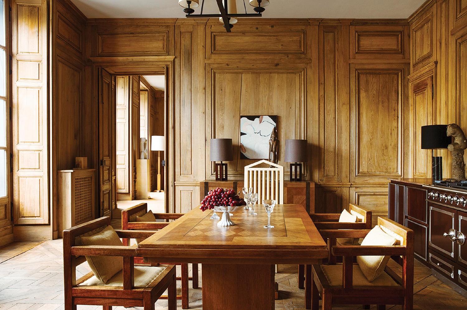 A dining room with a wooden table and chairs.