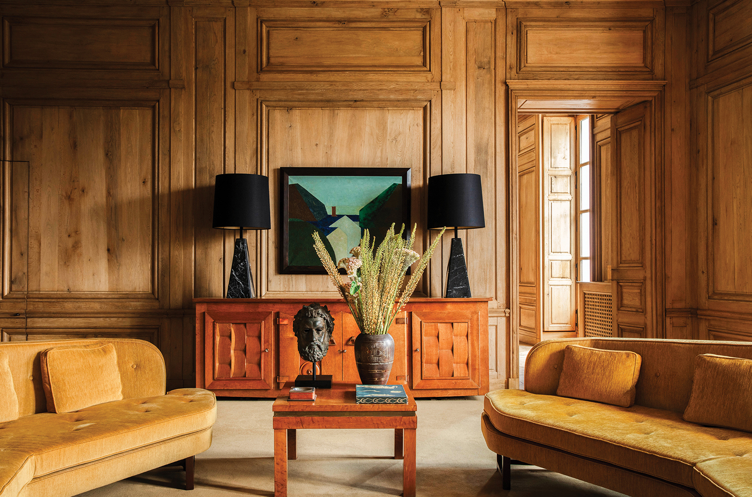 A living room with a couch, chair, and a table.