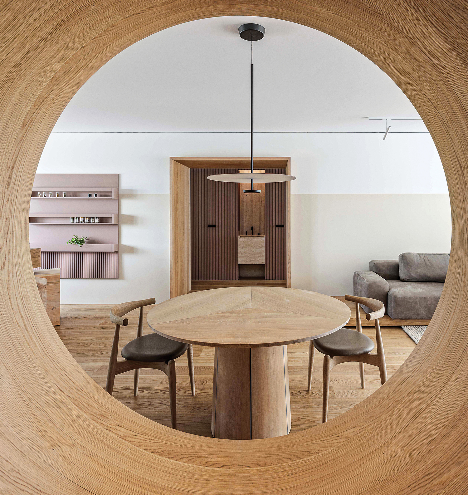 A circular table with chairs and a wooden table.