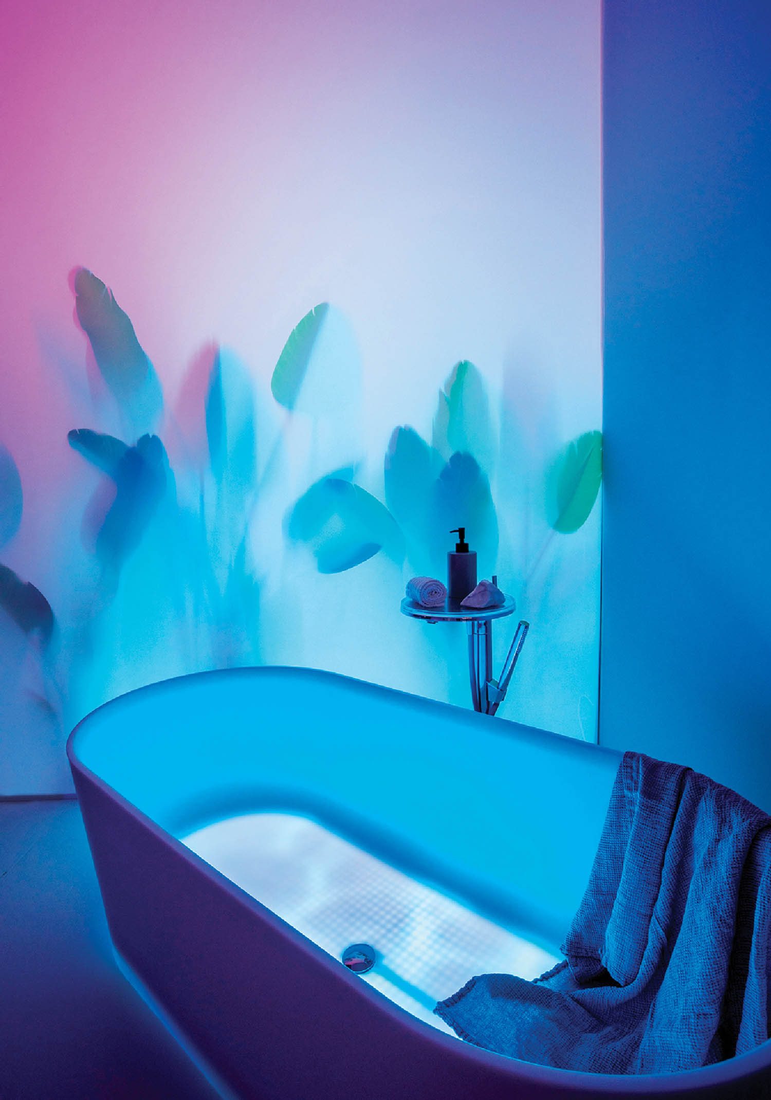 A bathtub with a towel and a towel on it.