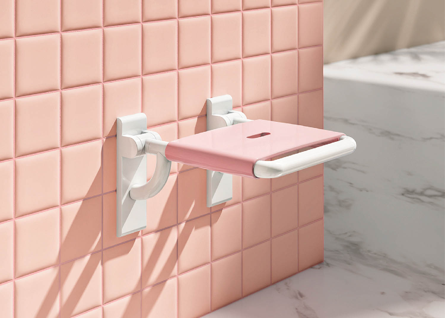 A pink bathroom with a white toilet and a pink tile wall.