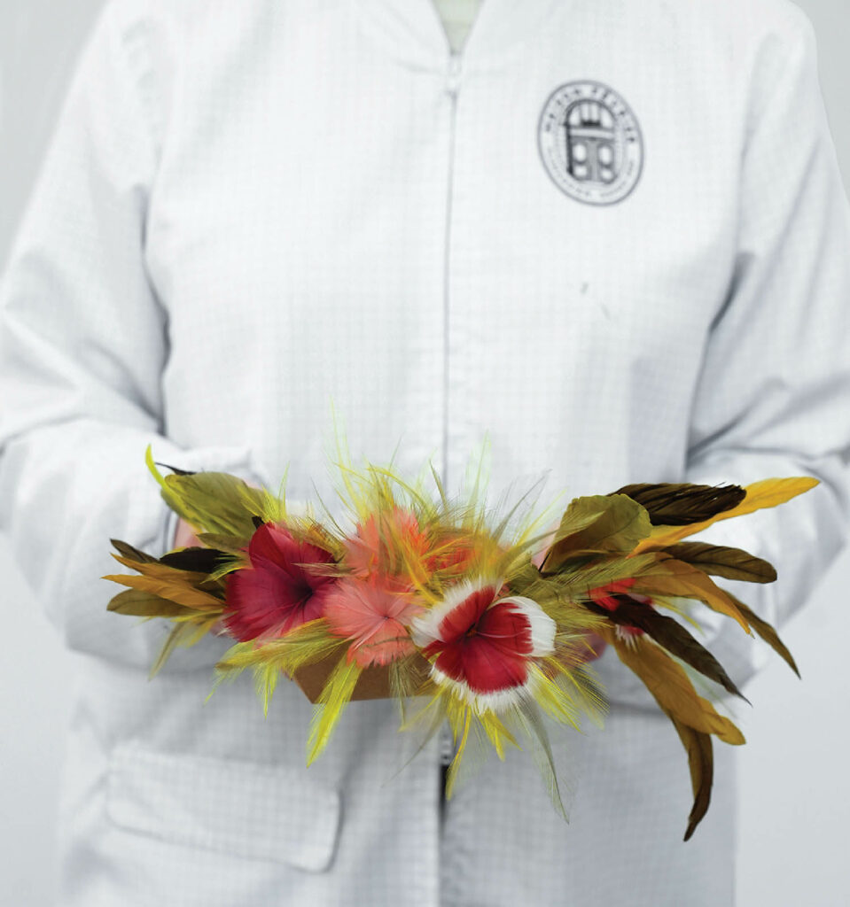 A person wearing a white shirt and a white shirt holding a flowe.