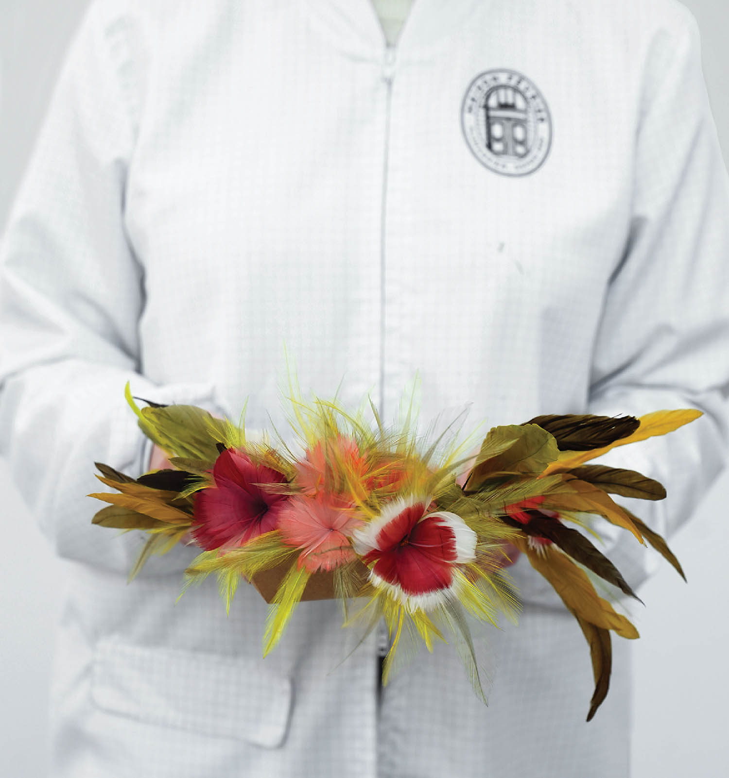 A person wearing a white shirt and a white shirt holding a flowe.