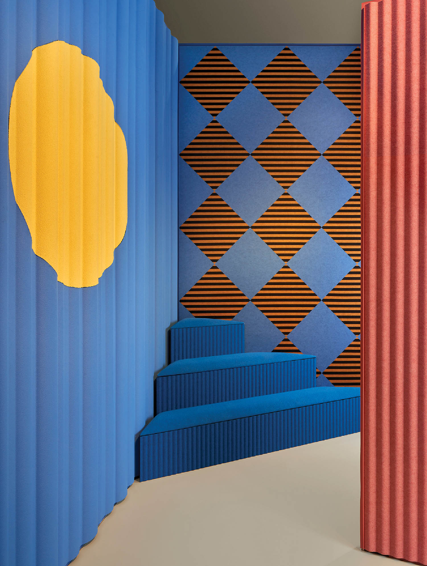 A room with a blue and yellow wall and a blue chair.