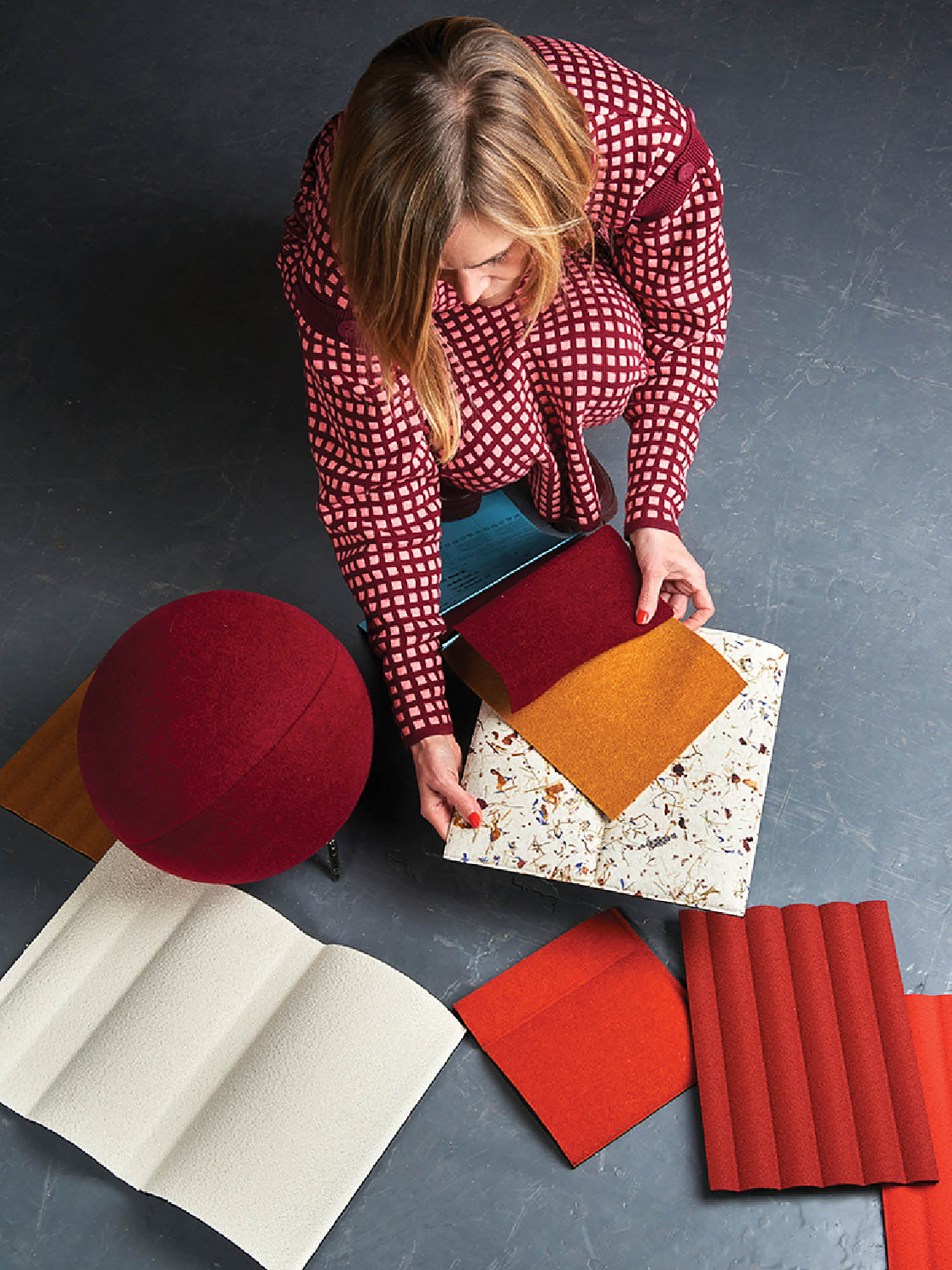 A woman is sitting on the floor with a piece of paper.