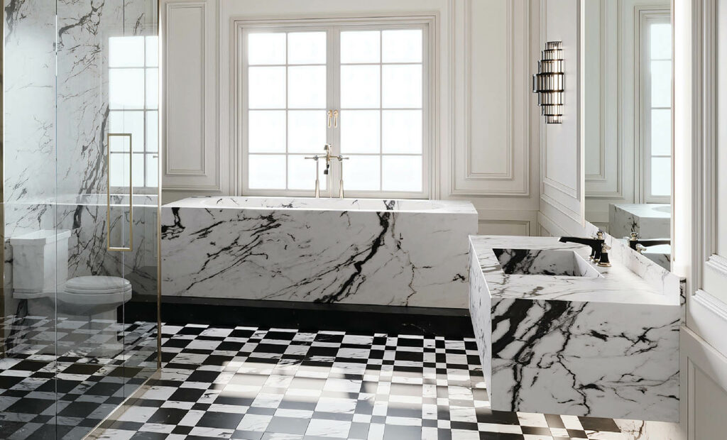 A bathroom with black and white marble flooring.