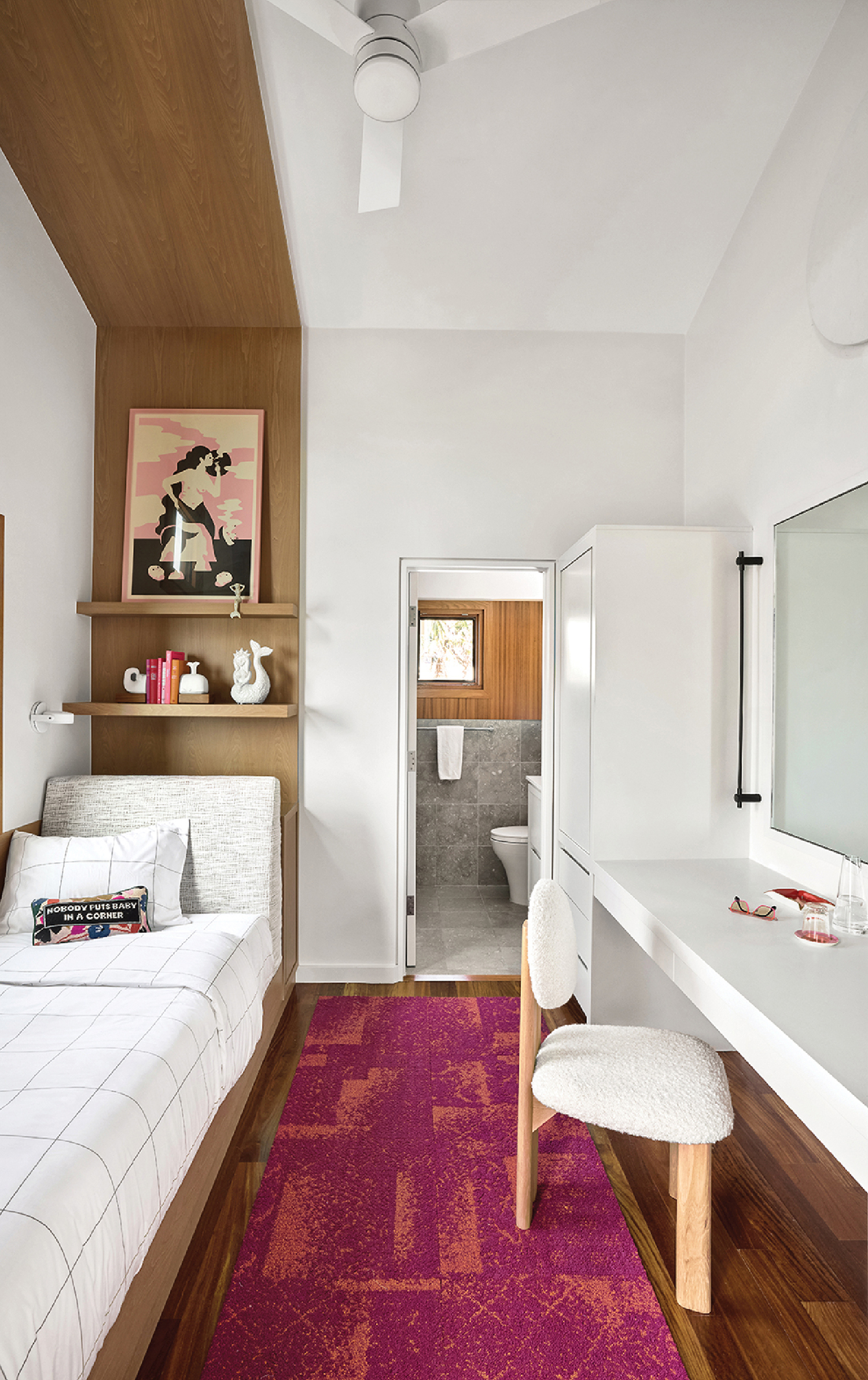 A bedroom with a bed and a desk.