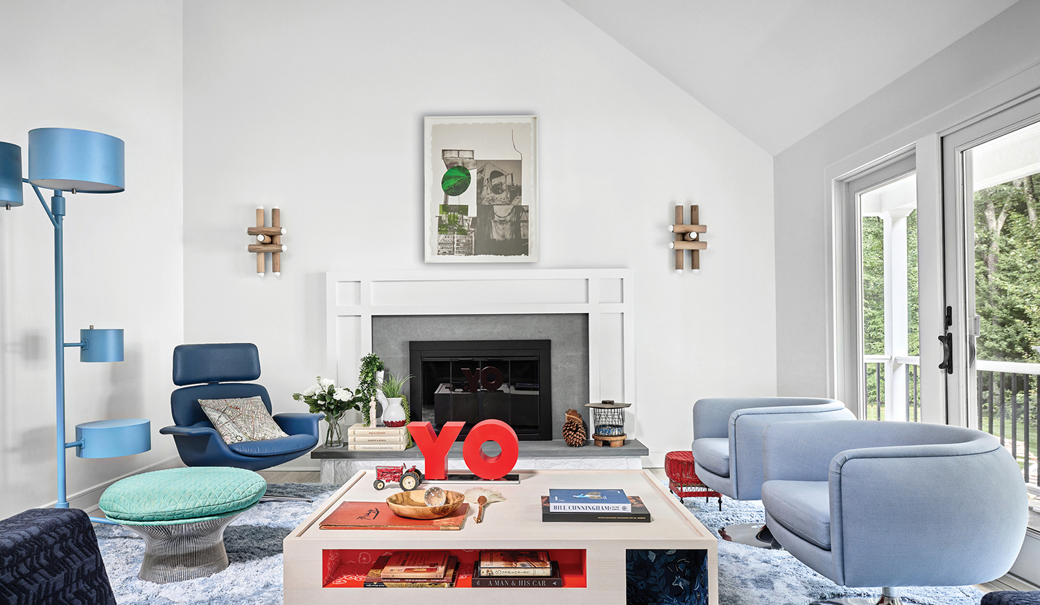 A living room with a fireplace and a blue chair.
