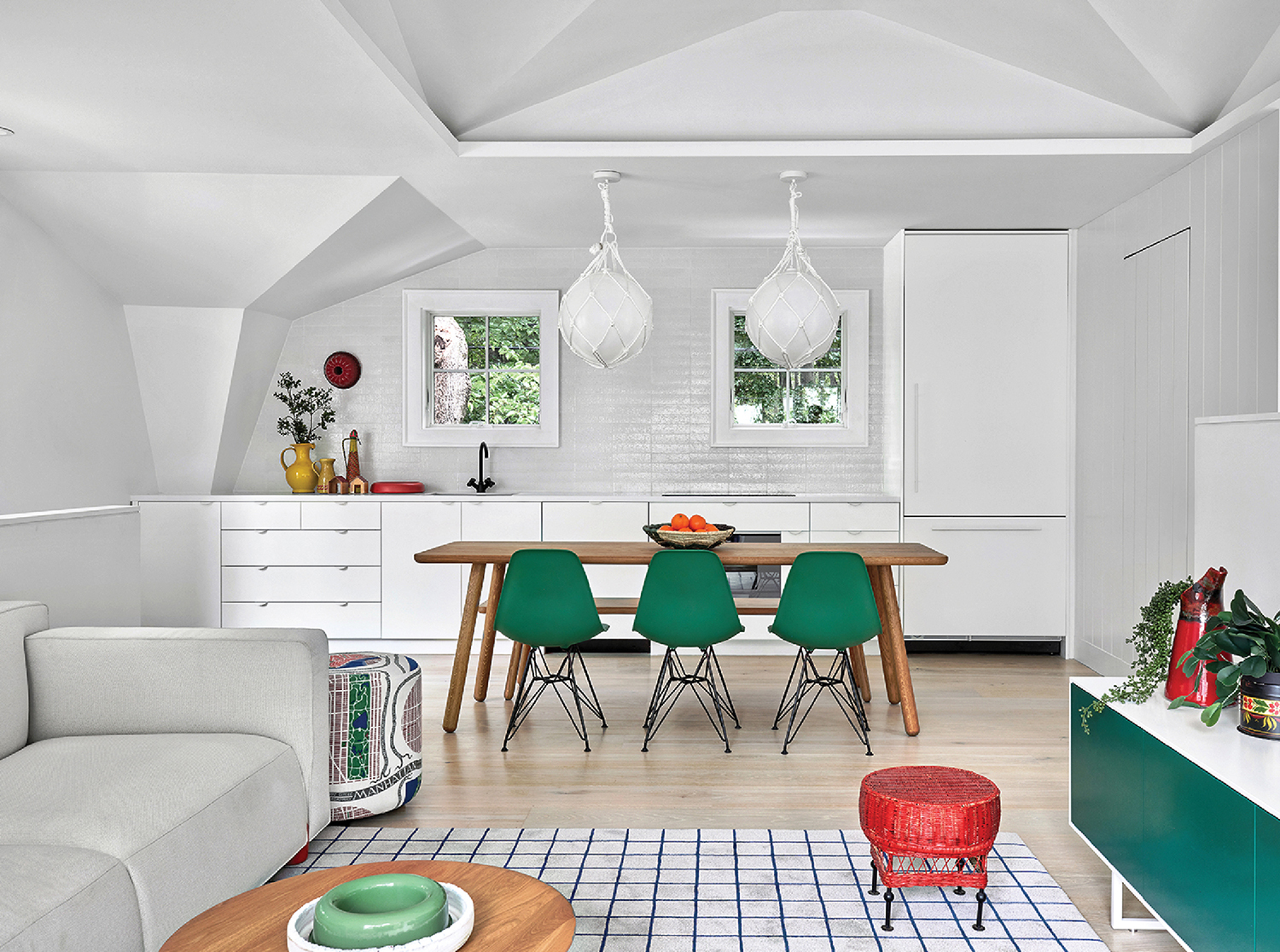 A living room with a couch, table, and chairs.