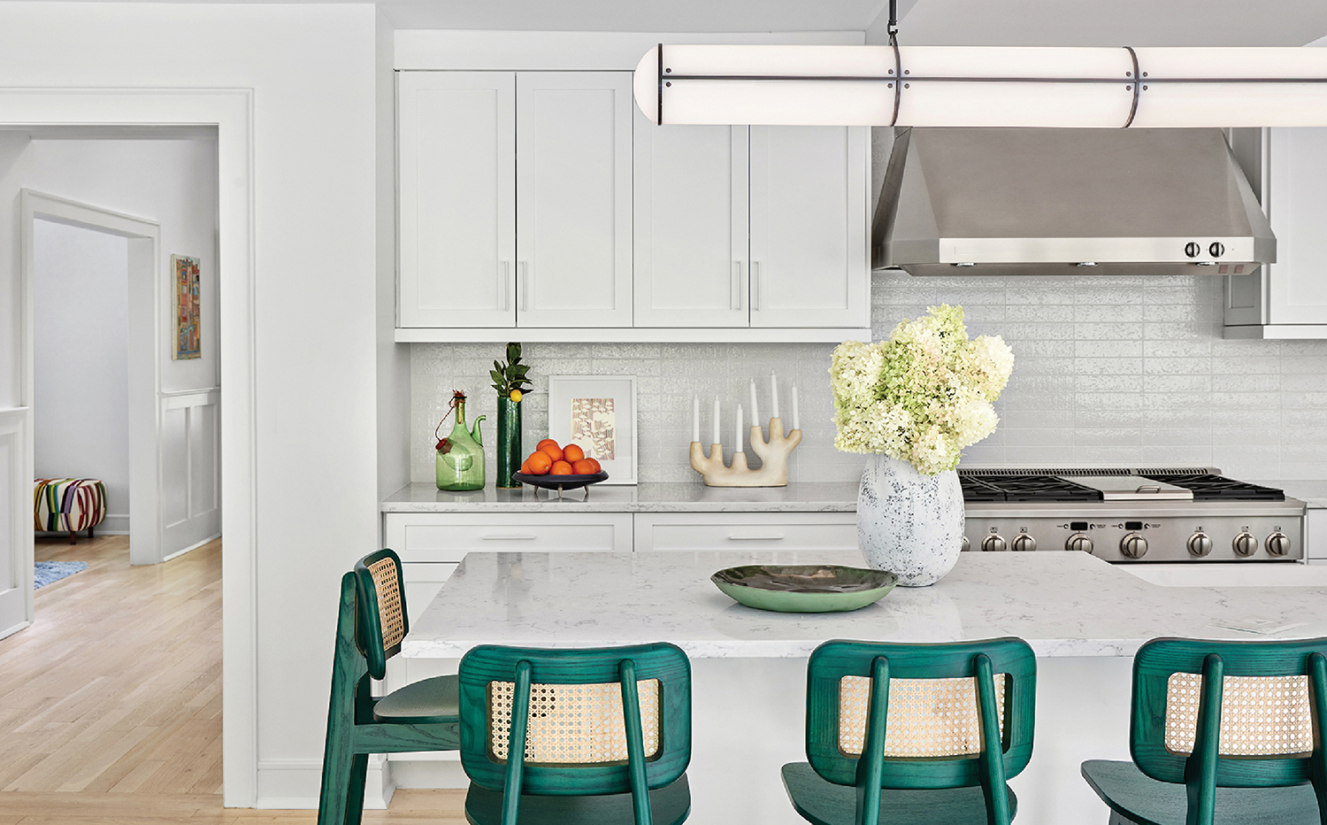 A kitchen with a white counter and a green chair.