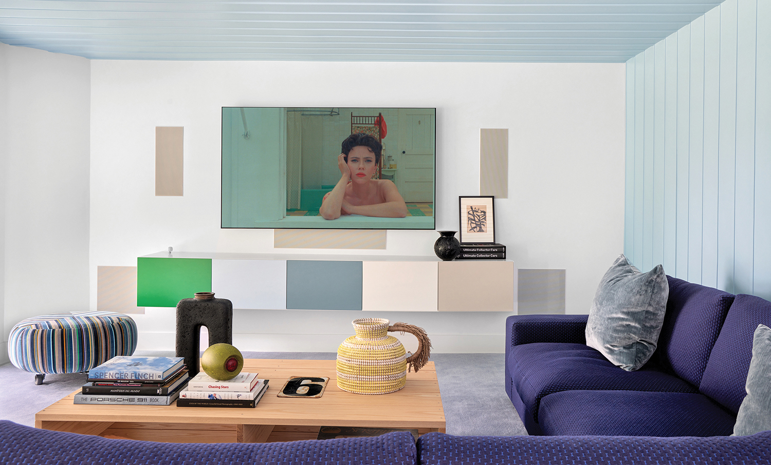 A living room with a television and a couch.