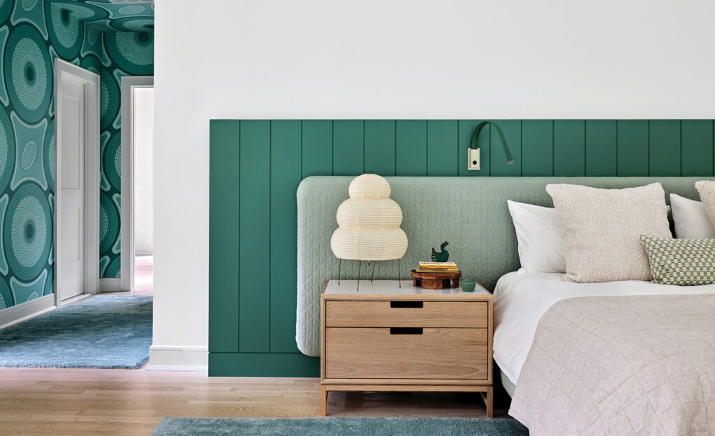 A bedroom with a bed and a nightstand.