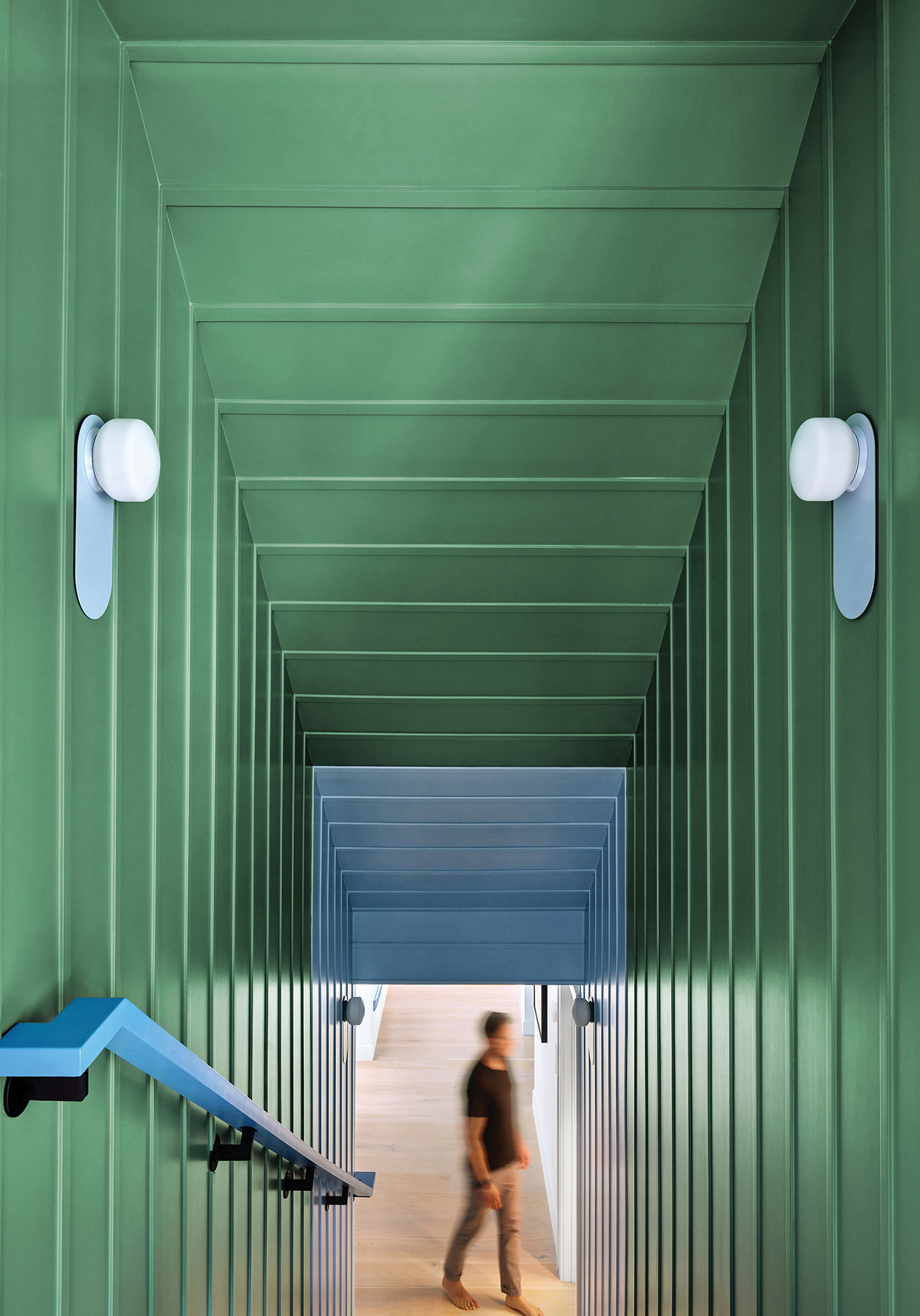 A person walking down a long hallway.