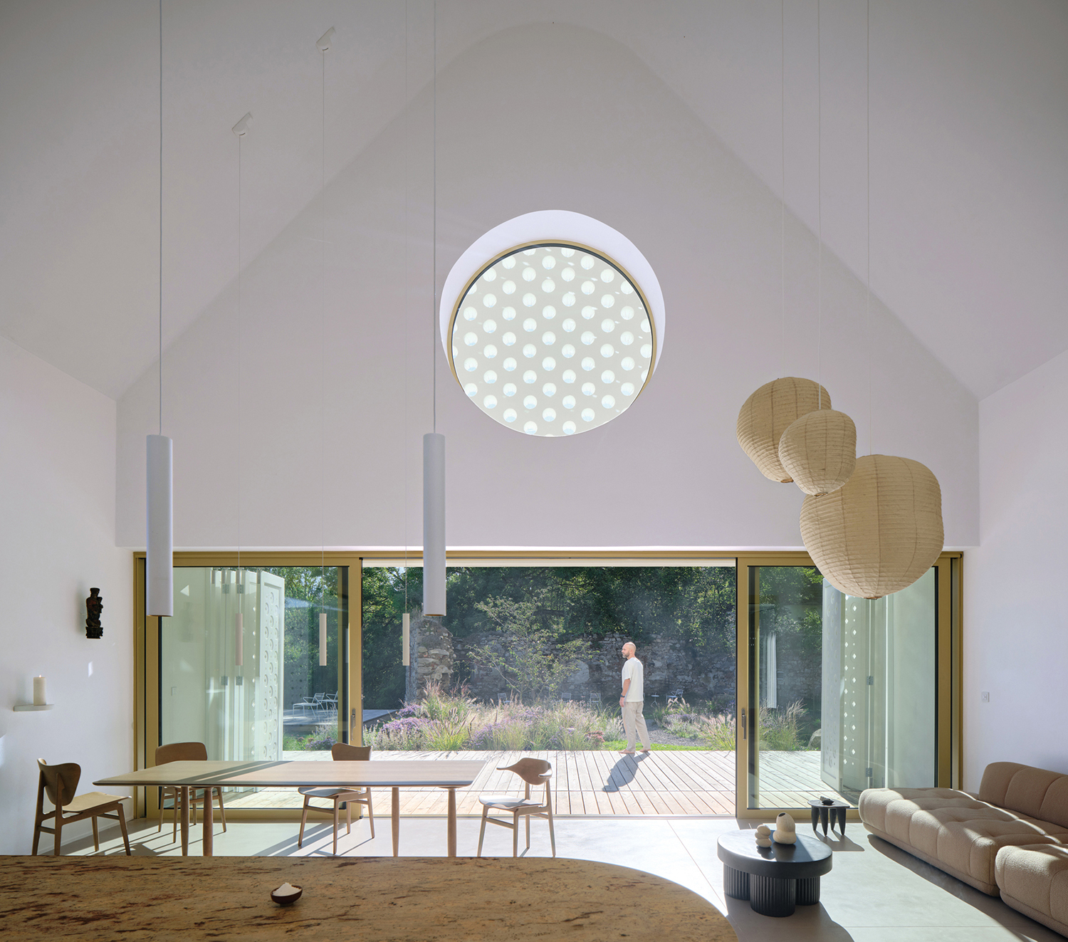 A living room with a large round window.